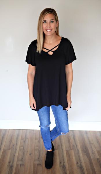 The Finley Top is a black criss cross short sleeve top. 