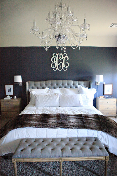 Master bedroom featuring navy walls, white bedding, tufted linen headboard and bench